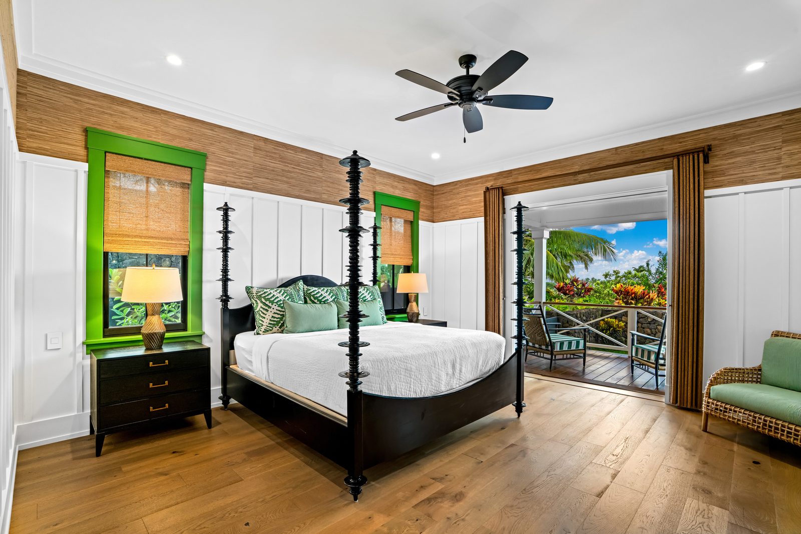 Green Room with a dark four-poster bed, emerald window trim and doors open to the lanai