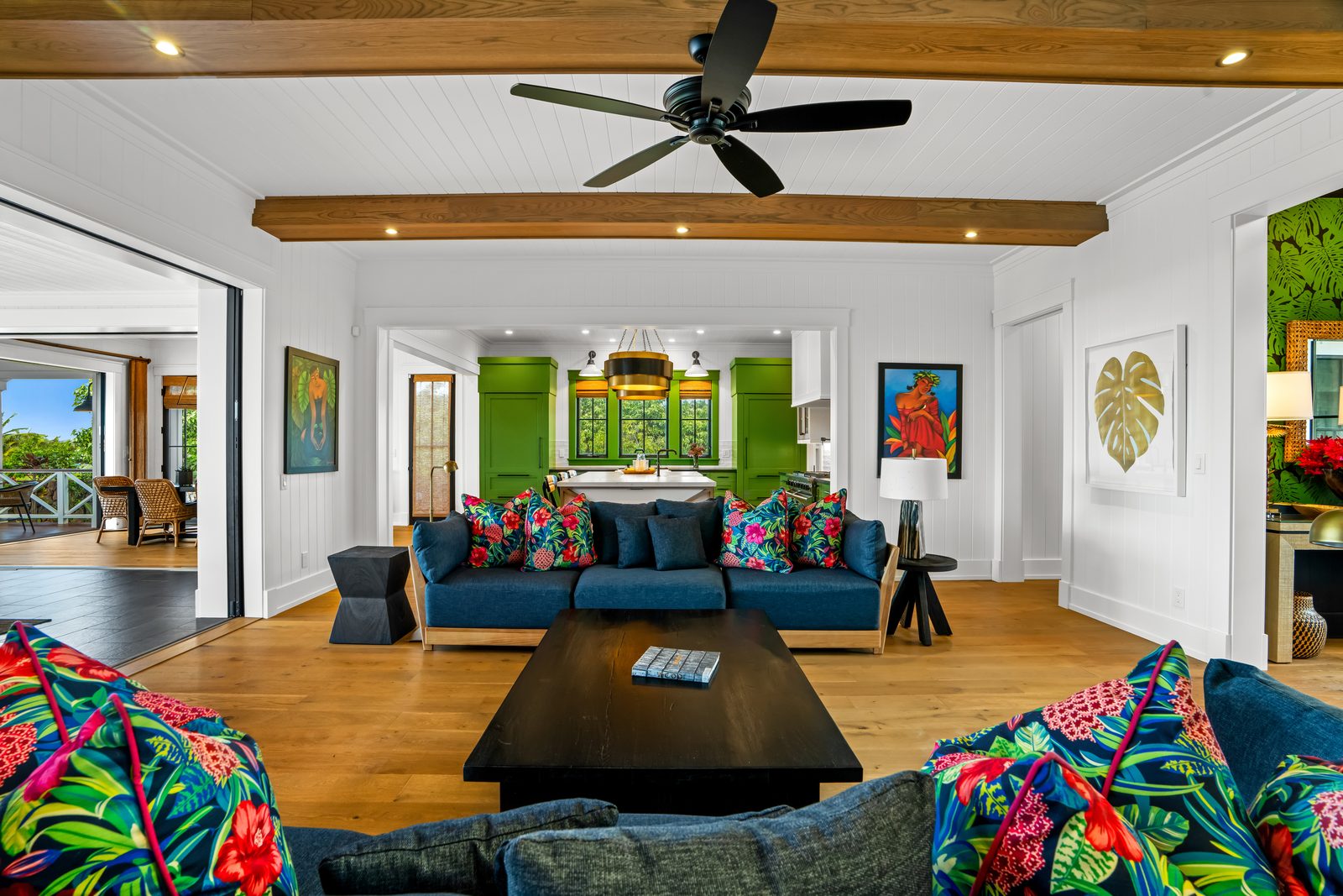 Sofas and armchairs in the great room, facing the green kitchen