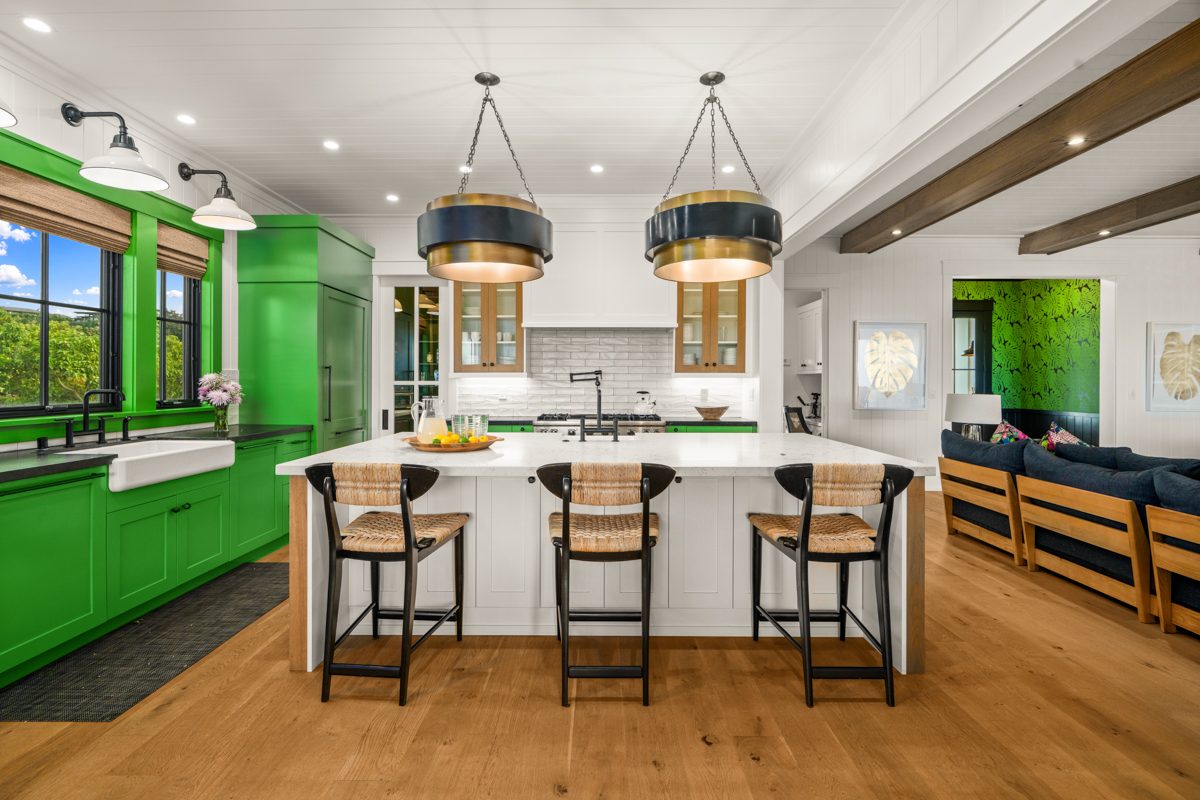 The emerald kitchen with its marble island and bar stools