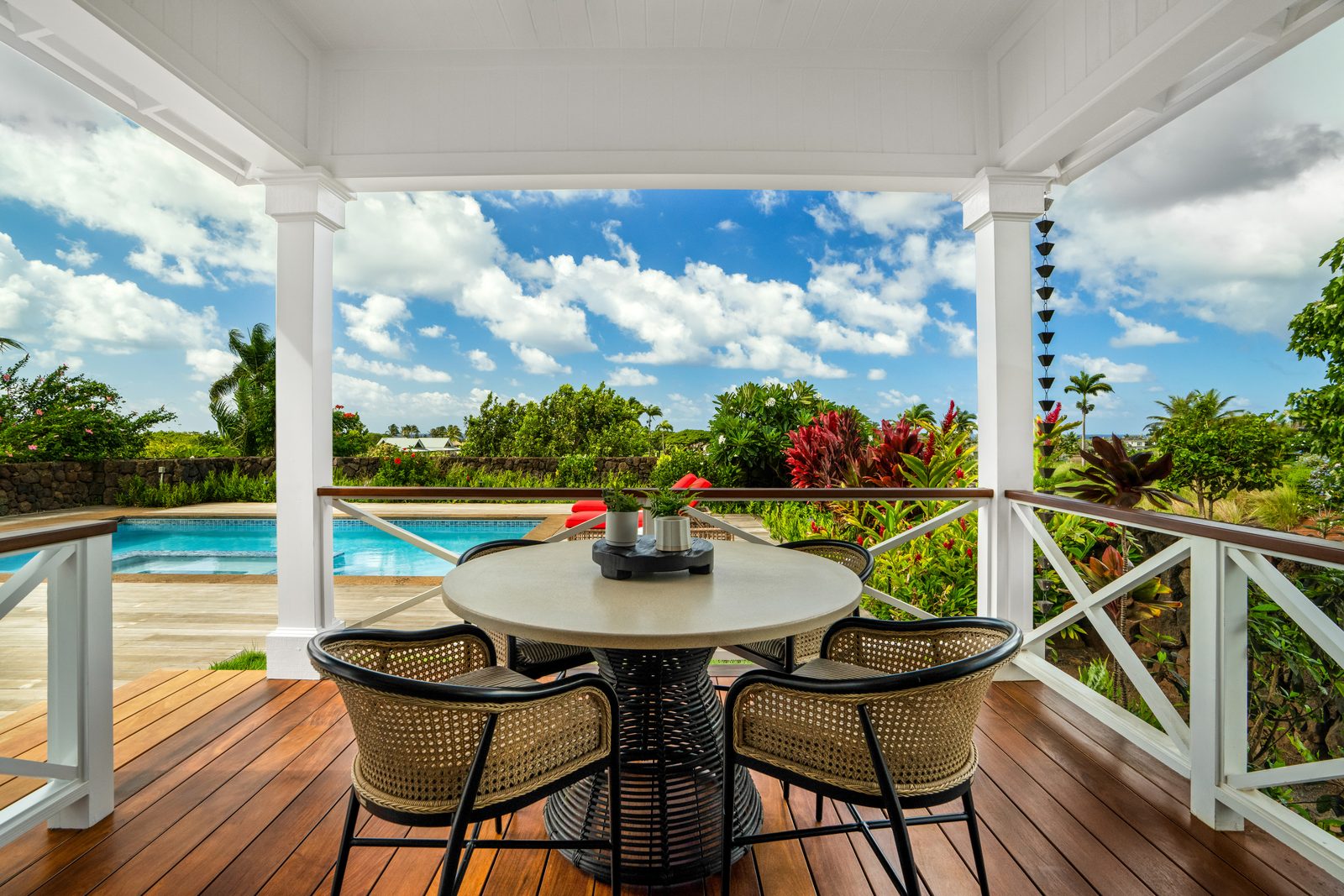 A round lanai table set for coffee above the pool