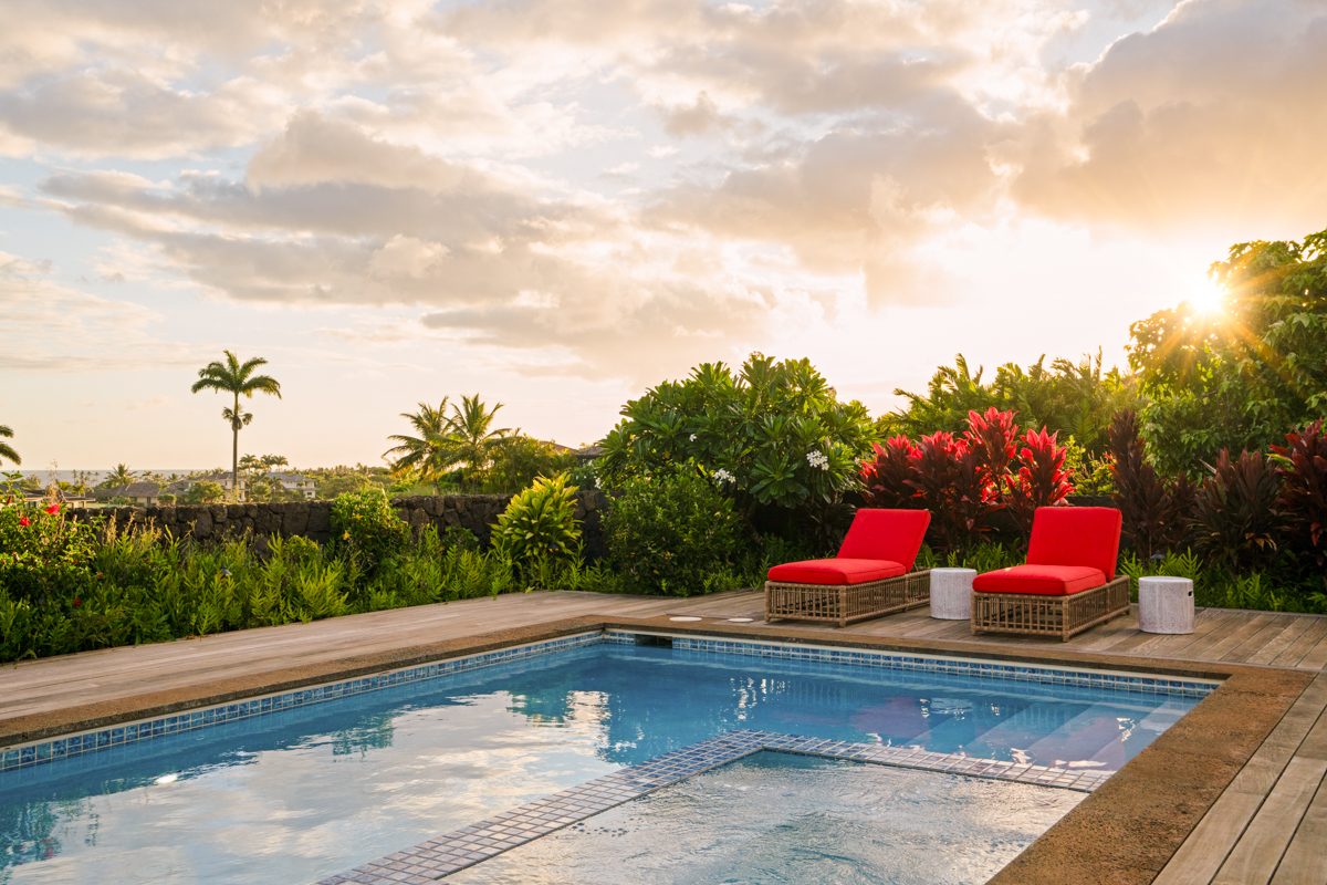 The pool at golden hour with the ocean beyond
