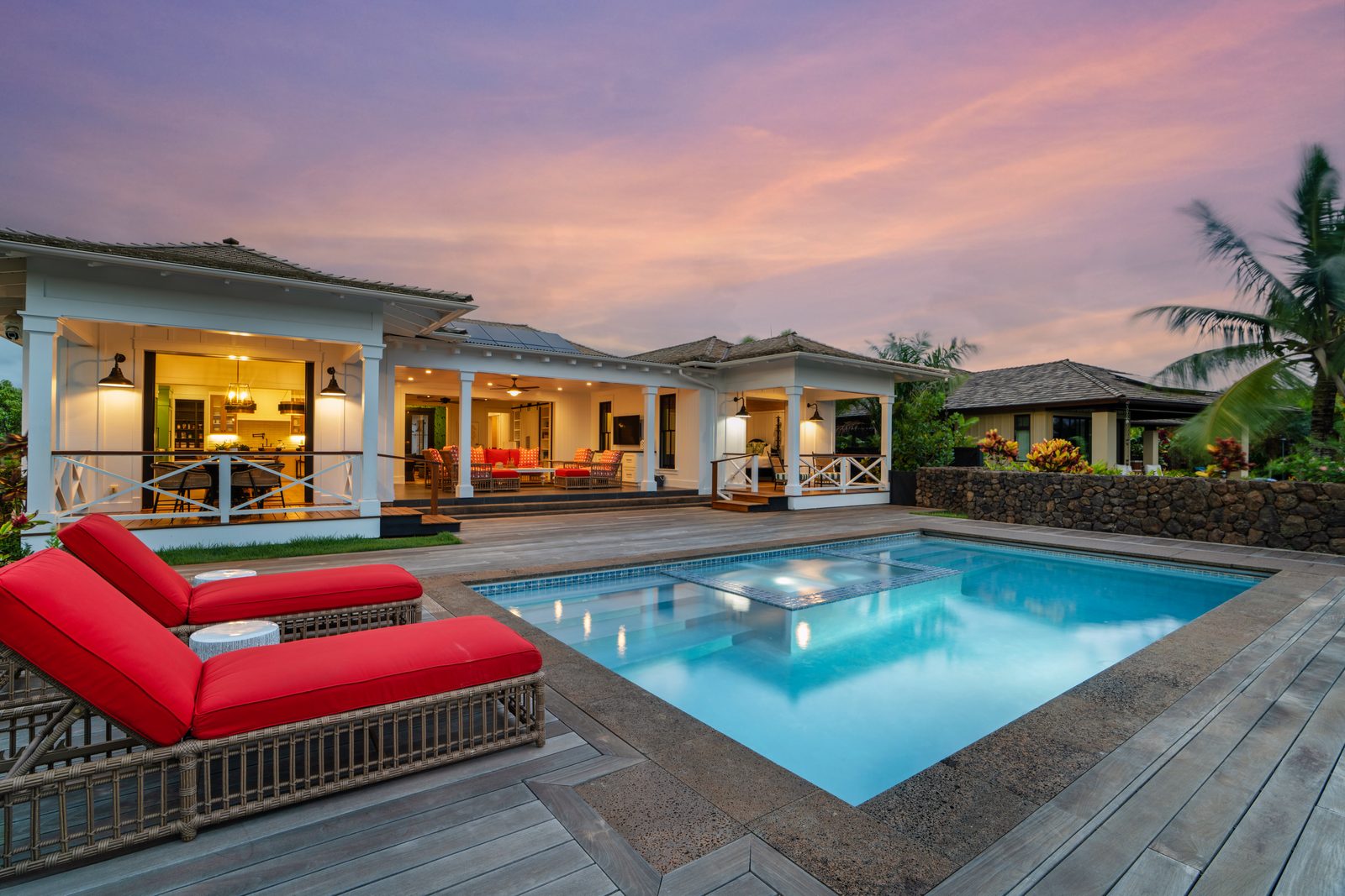 Coral loungers on the teak deck beside the pool