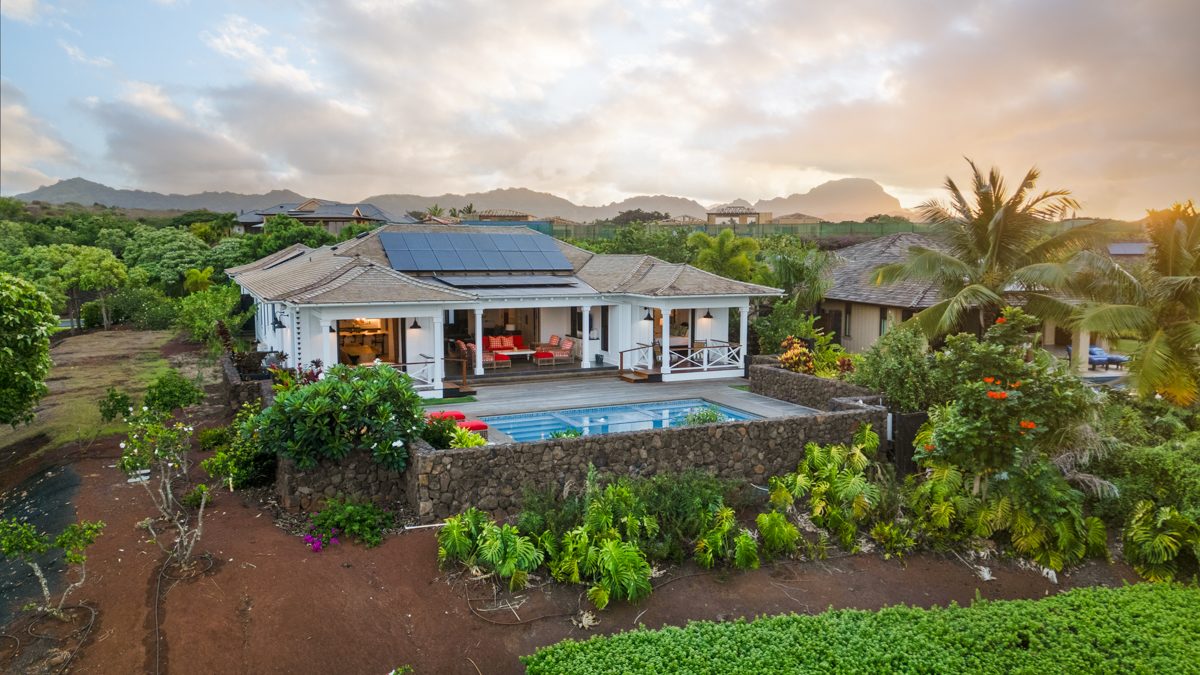 Aerial view of the house and pool with the mountains behind